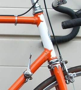 Frame and forks Orange with white head and seat tube panel. Chrome front and rear ends.