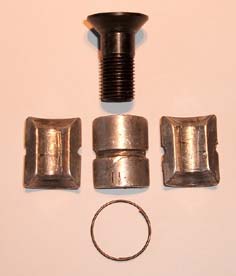 Image of the three segments, expanding screw and spring when off the body