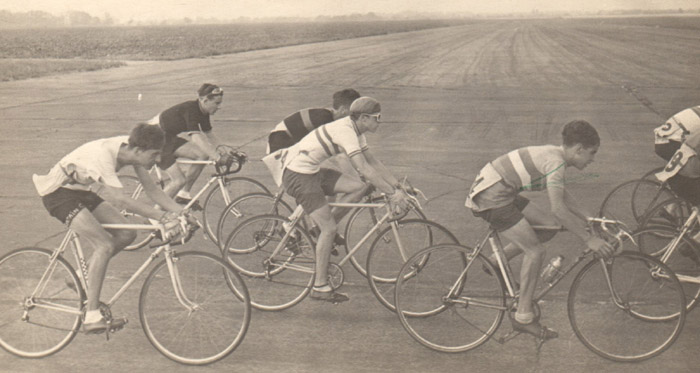 1 - Mass-start racing on perimeter track at the old airfield (main runway in background) at Matching Green, Essex 1948/9 Jim Case on right with his Leach Marathon with Osgear and Major Taylor stem