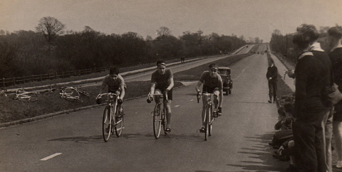 4 - Approaching the finish of the TTT on the Southend Road - Jim on left still driving on for the last few yards. Rider in centre sitting up and on right already undoing straps.