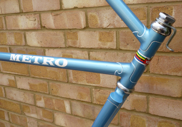 Permanent downtube decal produced by placing the vinyl transfer on a base colour and removing it after the final coat is applied to reveal the name
